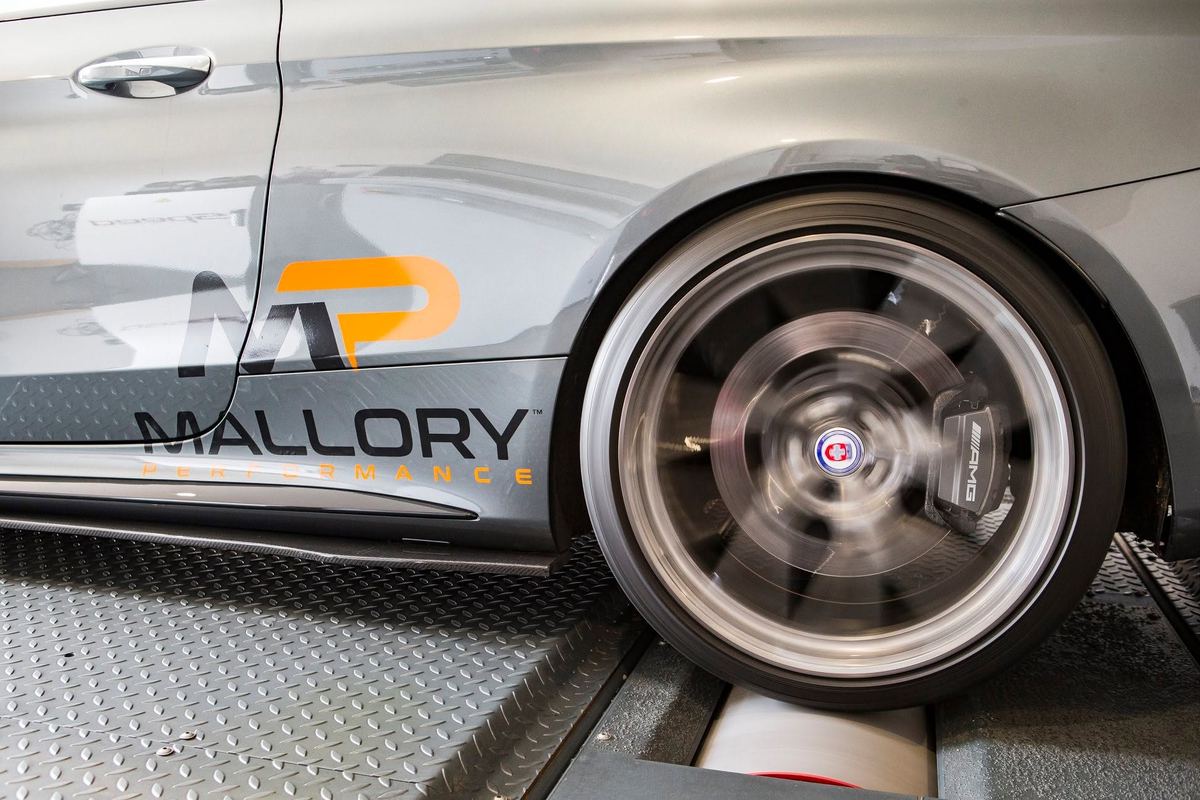 Mercedes-AMG C63 in Mallory Performance livery, wheel spinning on the rolling road